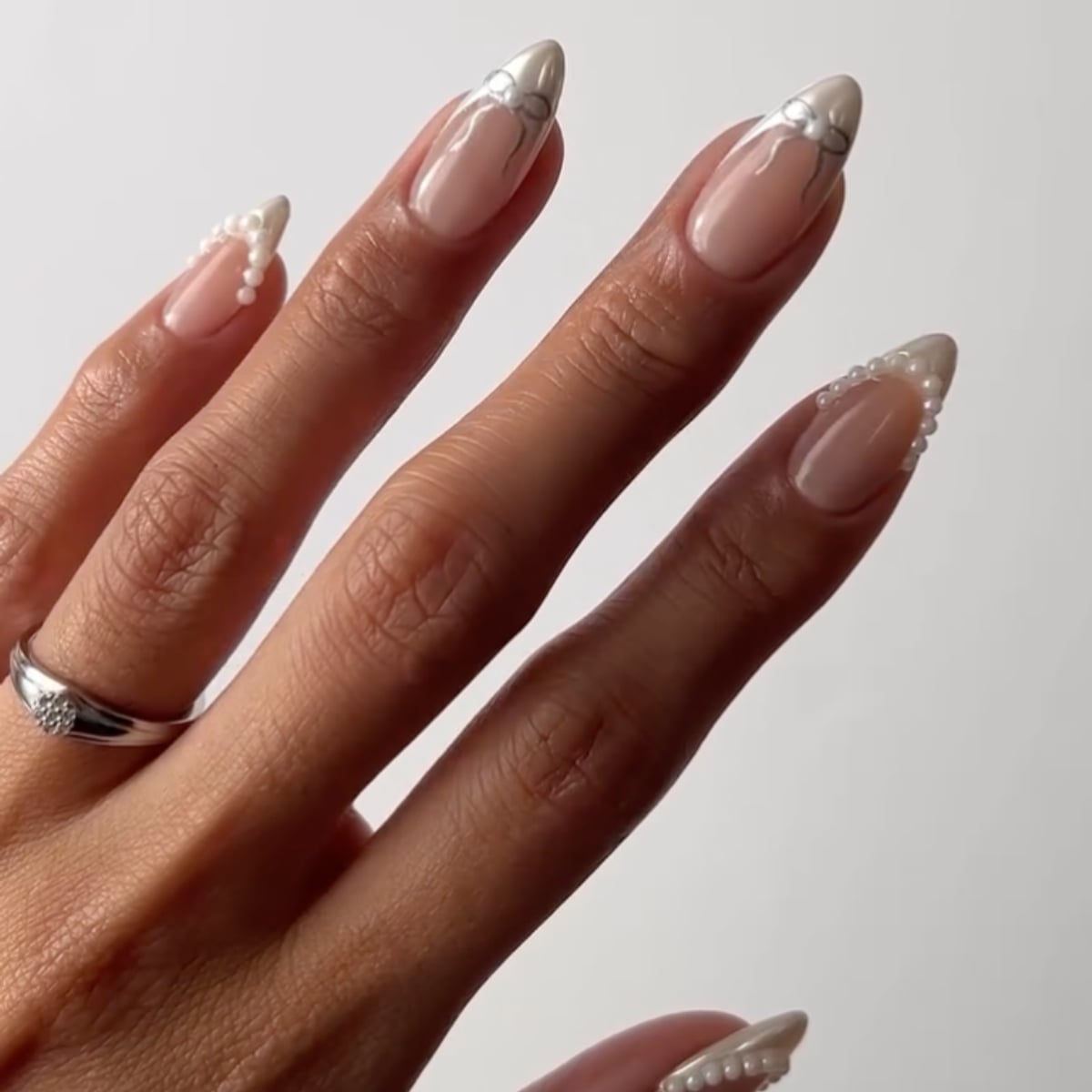 Medium Almond Nude Matte With Black Bows and Pearls — Trendy Coquette Nails