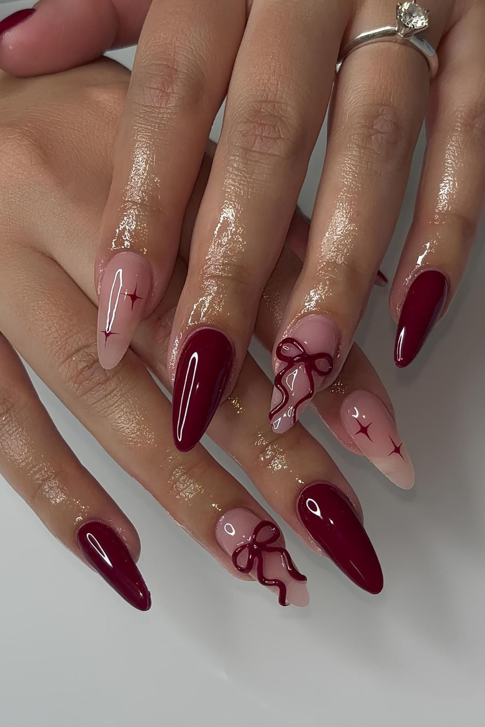 Long Almond Burgundy Nude With Dark Red Bows and Stars — Trendy Coquette Nails