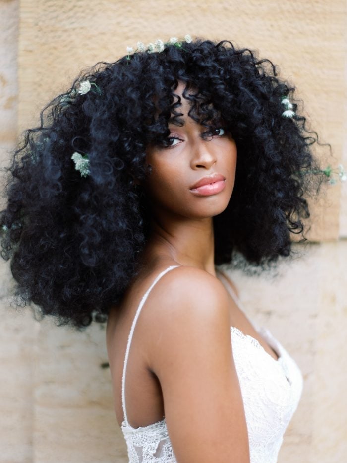 Voluminous Black Collarbone Curls With Curtain Bangs Voluminous Black Collarbone Curls With Curtain Bangs — Trendy Curly Hair Wedding