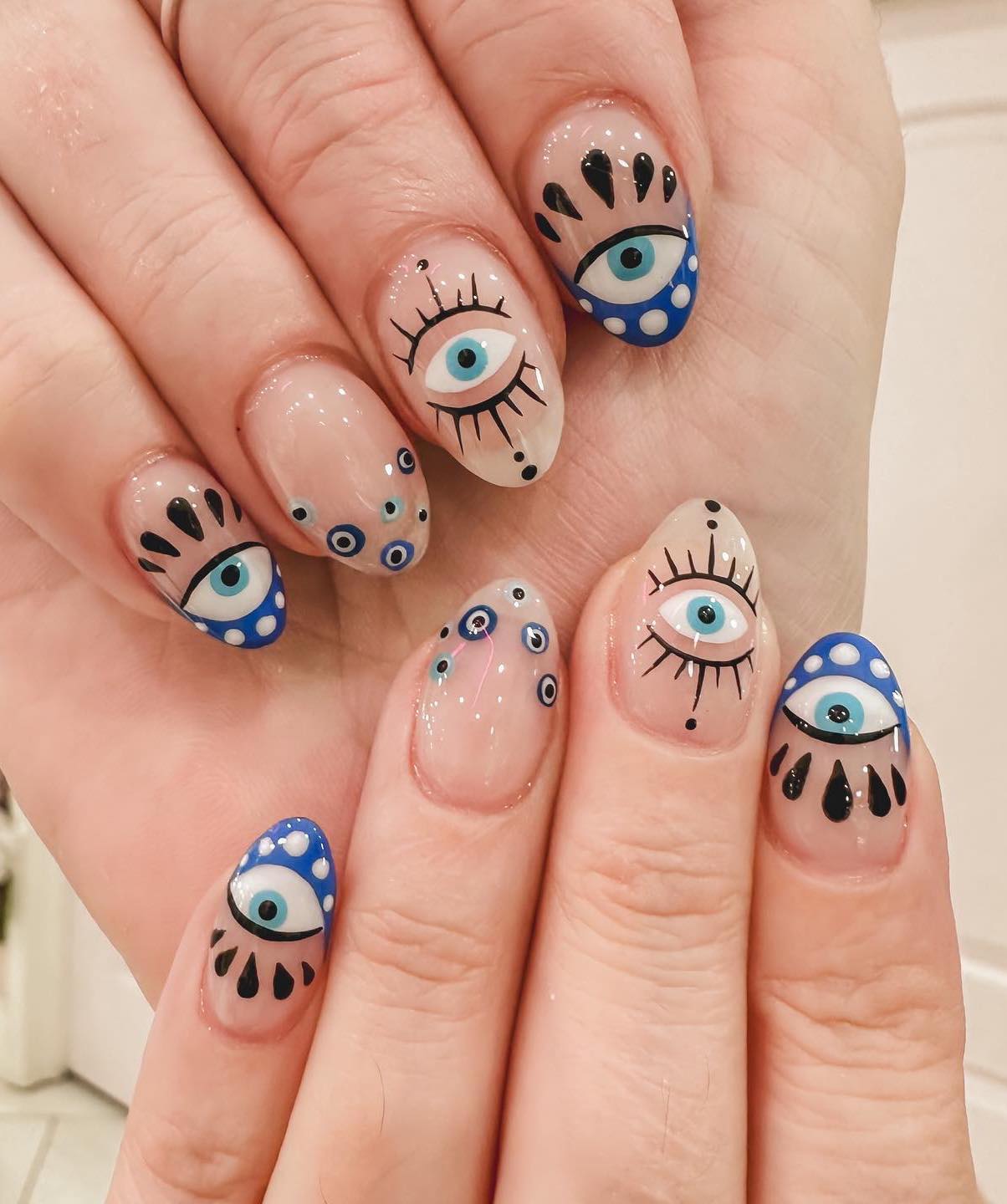 Intricate Evil Eye Medium Almond Nails Intricate Evil Eye Medium Almond Nails — Trendy Evil Eye Nails