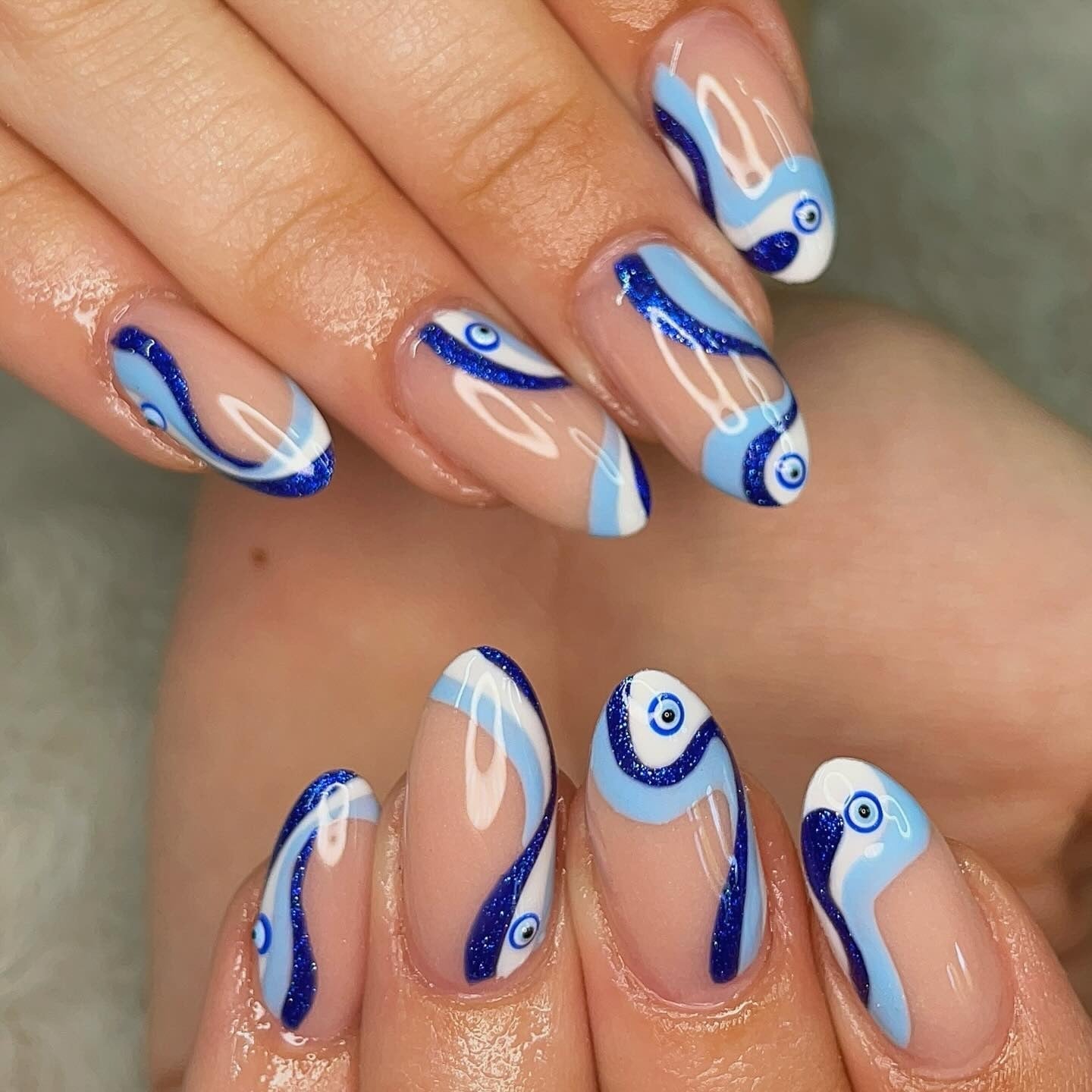 Wavy Blue Evil Eye Medium Almond Nails Wavy Blue Evil Eye Medium Almond Nails — Trendy Evil Eye Nails