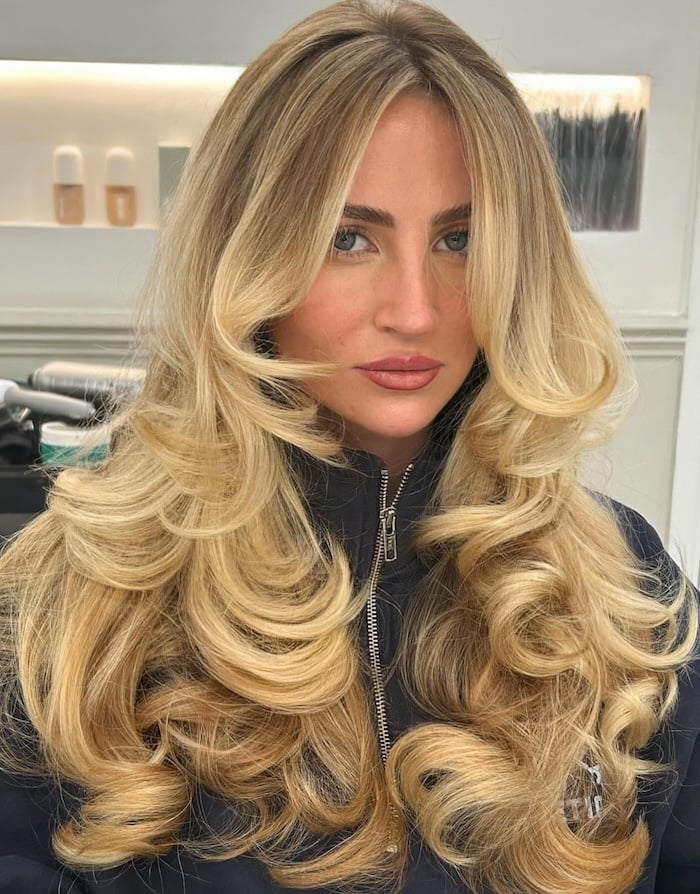 Voluminous Golden Blonde With Curtain Bangs Voluminous Golden Blonde With Curtain Bangs — Trendy Golden Blonde