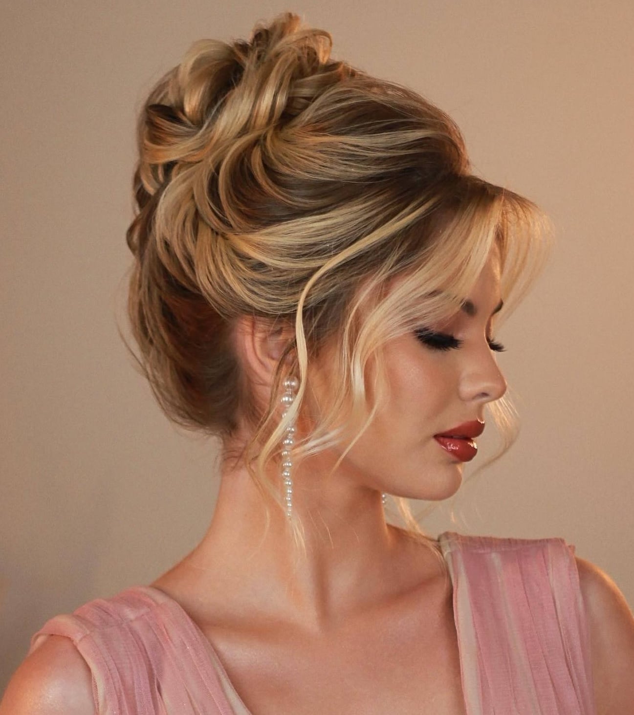 Voluminous Honey Blonde Updo With Face-Framing Bangs — Trendy Hair Up Hairstyles