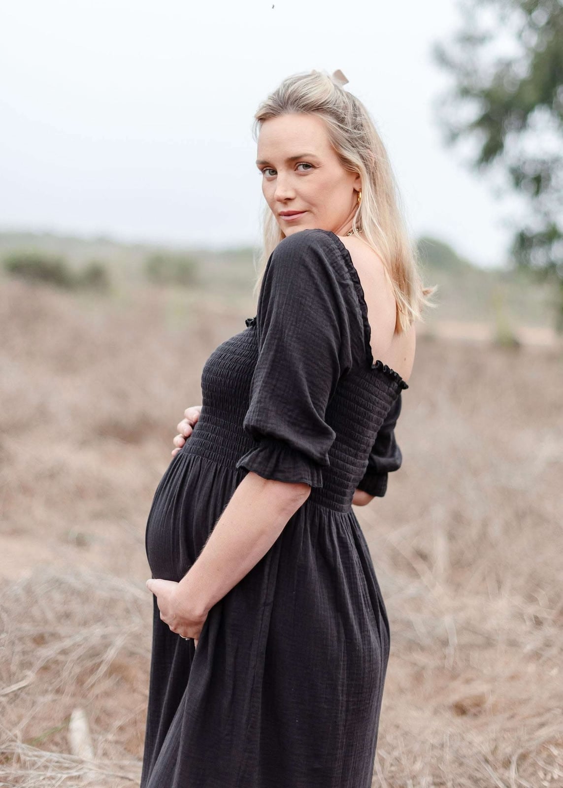 Black Smocked Maternity Dress With Empire Waist — Trendy Maternity Outfits
