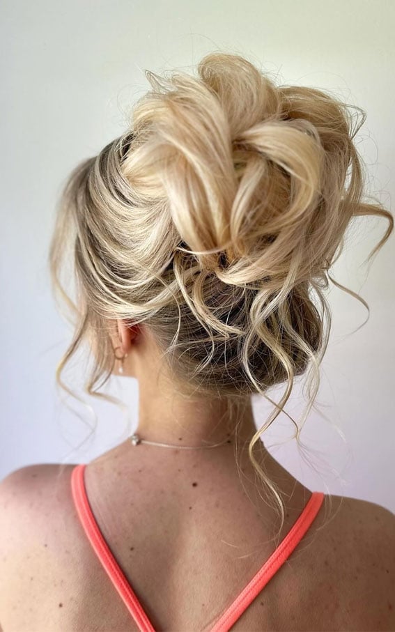 Voluminous Tousled Updo With Loose Tendrils — Trendy Messy Bun Updo