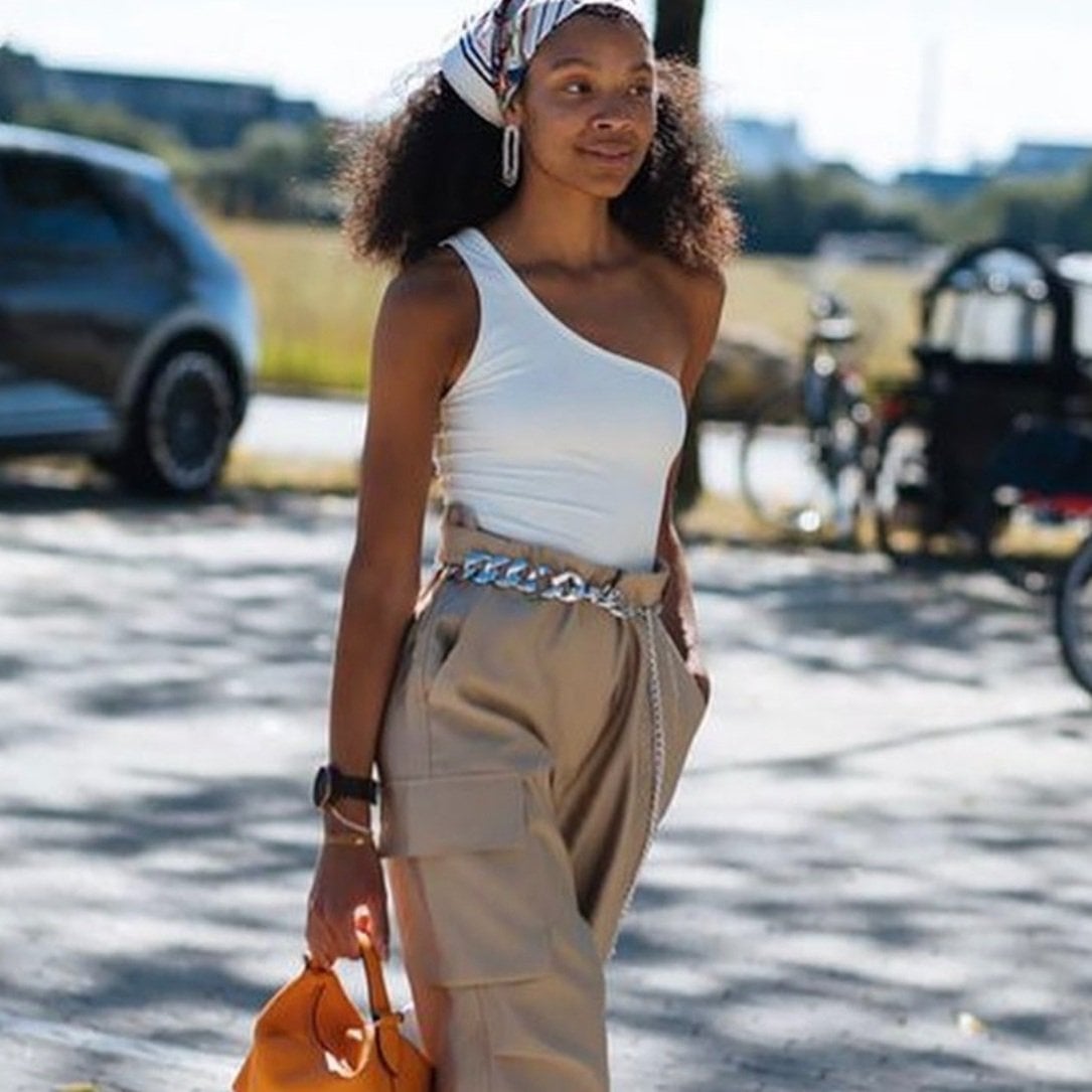 White One-Shoulder Top with Beige Cargo Pants and Chain Belt — Trendy Monday Outfit