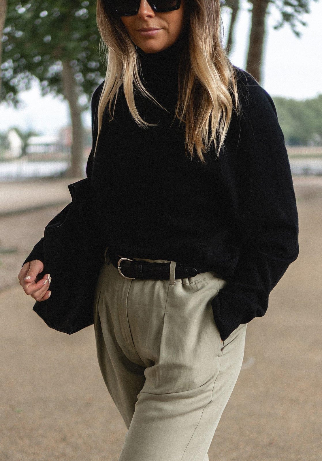 Black Turtleneck with Beige Trousers and Leather Belt — Trendy Monday Outfit