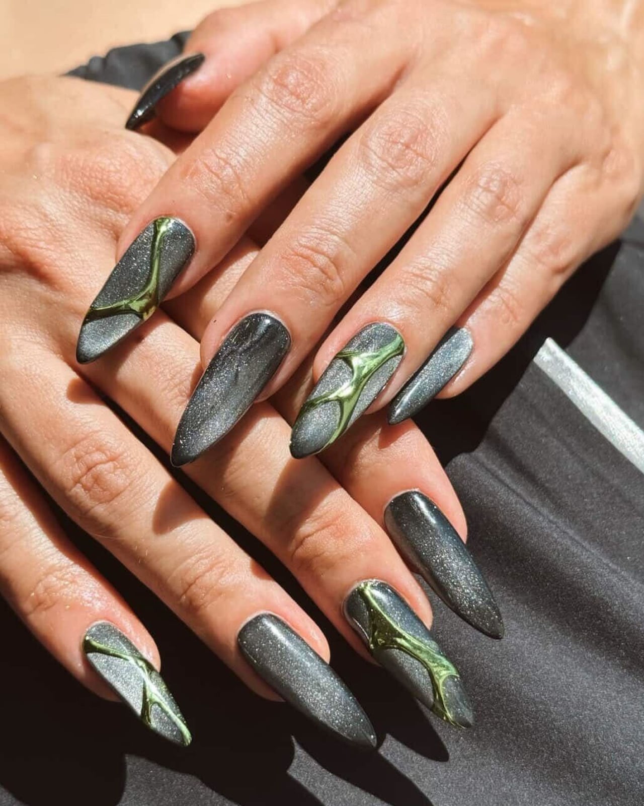 Dark Grey Cat-Eye Stiletto Nails with Green Accents — Trendy Nails for Black Dress