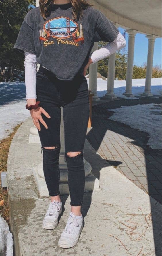 Grey Graphic Tee Over White Shirt with Ripped Jeans Grey Graphic Tee Over White Shirt with Ripped Jeans — Trendy Outfits for Teens
