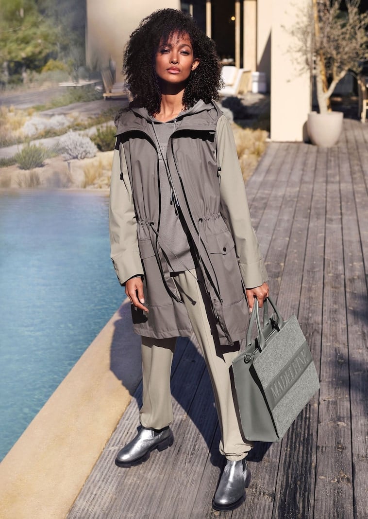 Grey Hooded Vest Over Beige Top — Trendy Rain Jacket Outfits