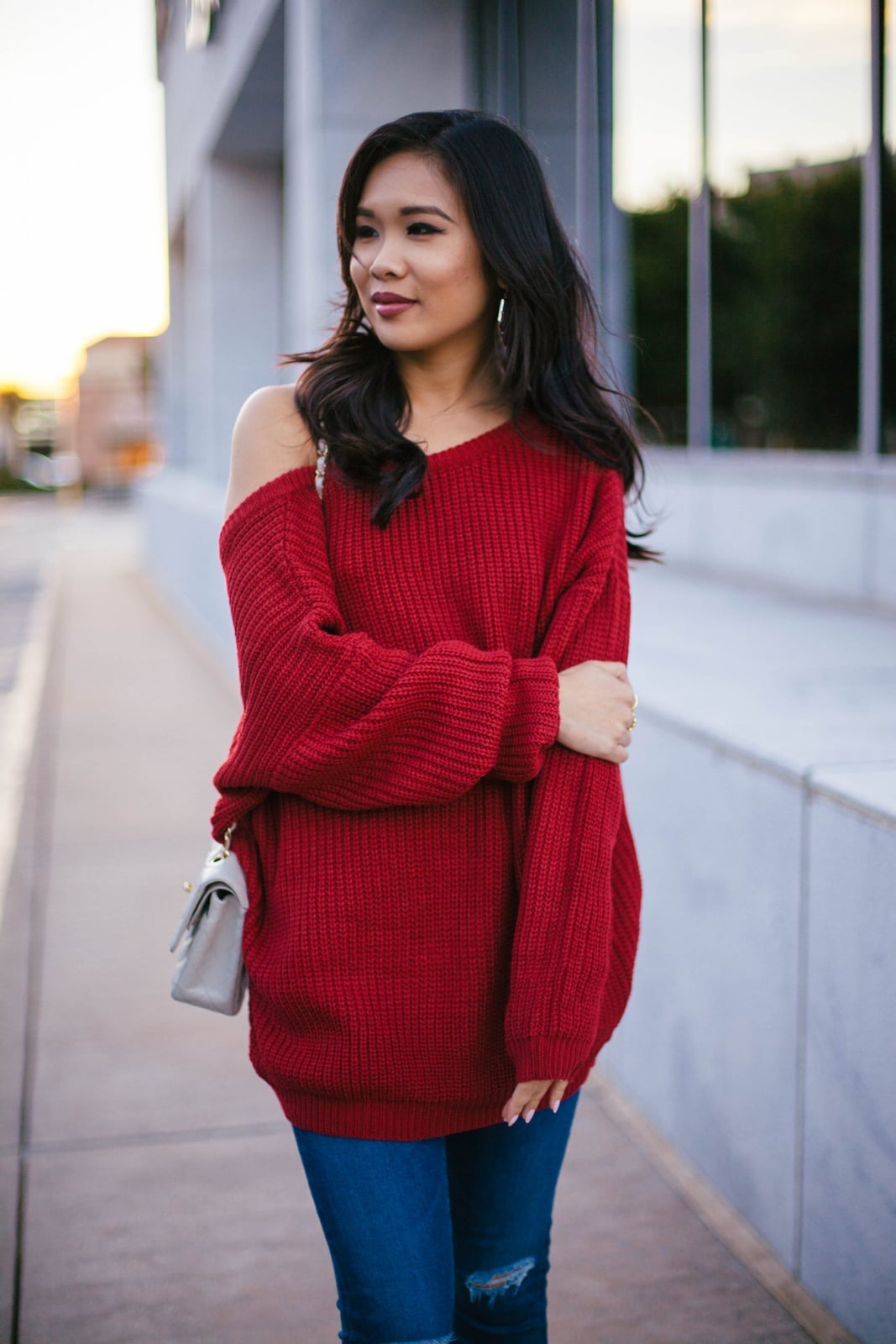 Red Off-Shoulder Sweater With Blue Jeans and Grey Bag — Trendy Red Sweater Outfit