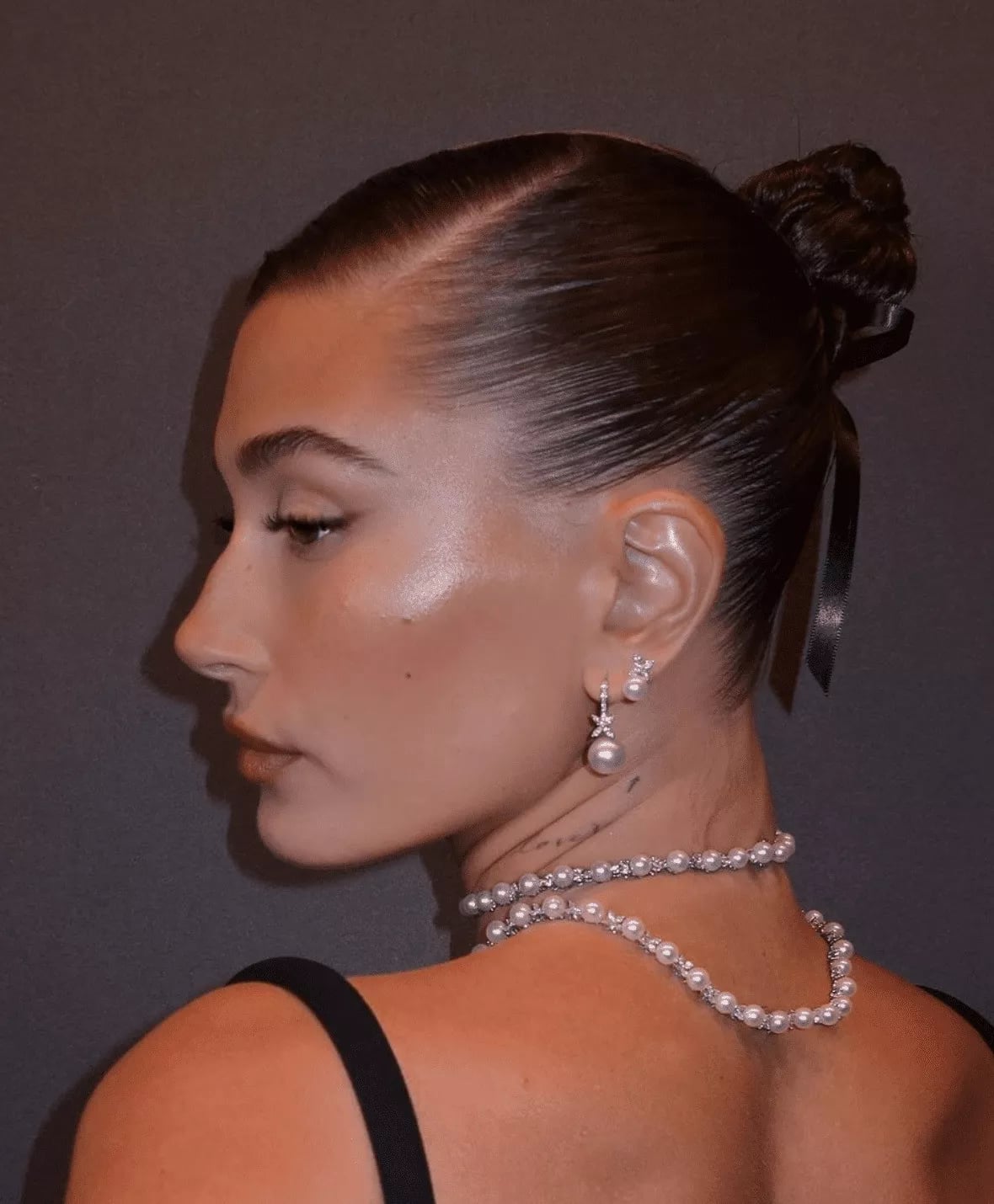 High Polished Dark Brown Bun With Ribbon — Trendy Slick Back Hairstyles