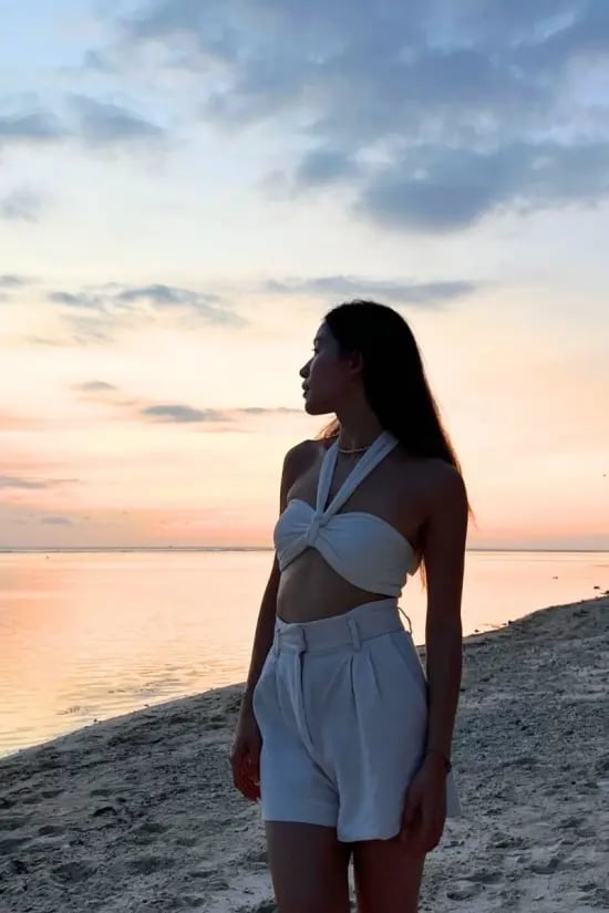 White Halter Crop Top with Beige Shorts — Trendy Sunset Outfit