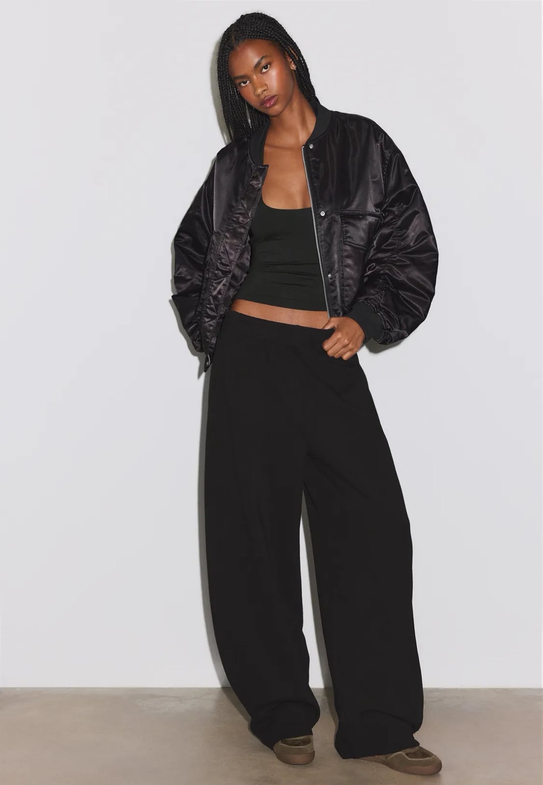 Satin Bomber Jacket Adds Glamour to Black Sweatpants, Close-Up Take Trendy Sweatpants Outfits