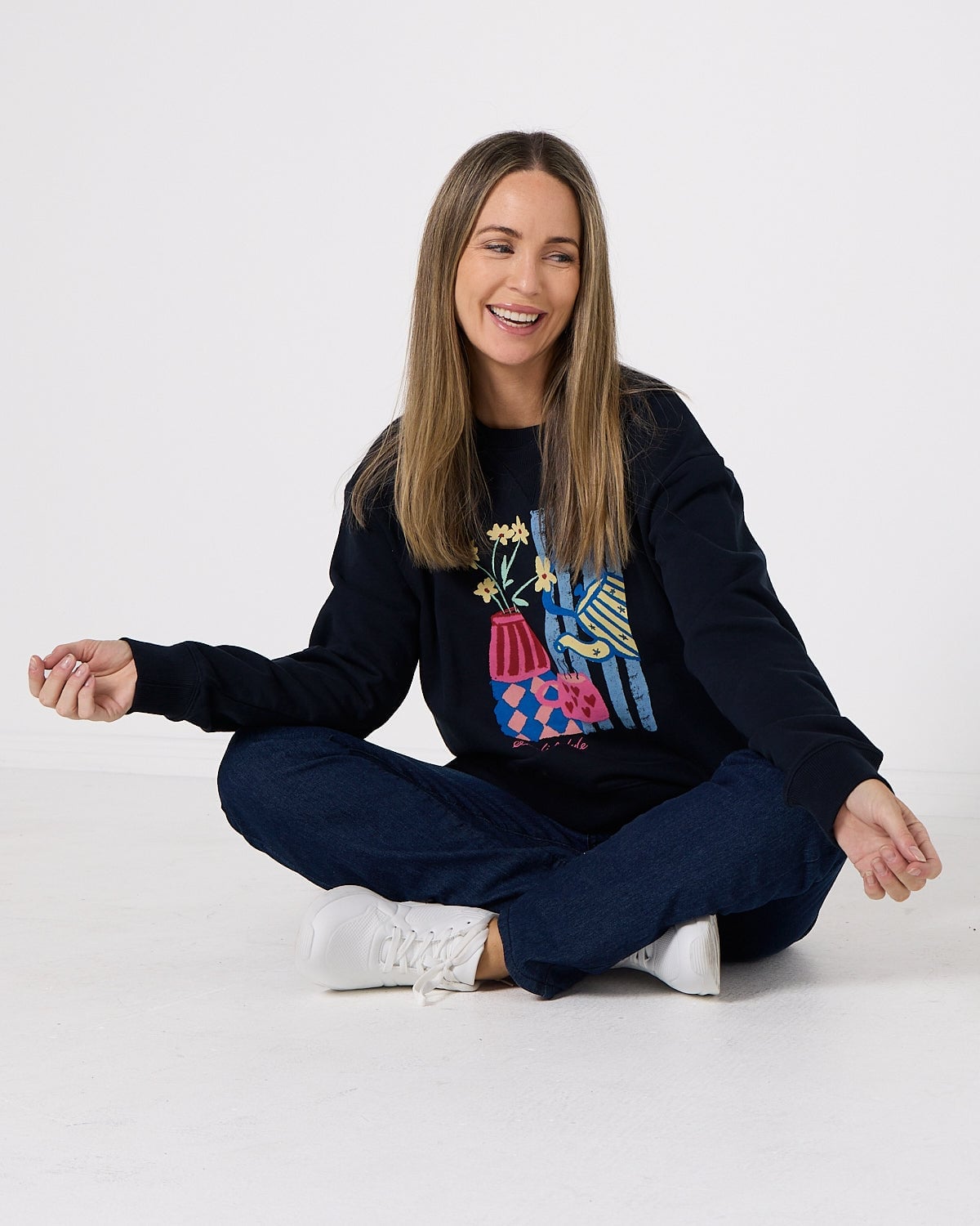 Navy Sweatshirt with Colorful Graphic Print and Wide-Leg Jeans — Trendy Sweatshirt Outfits Women