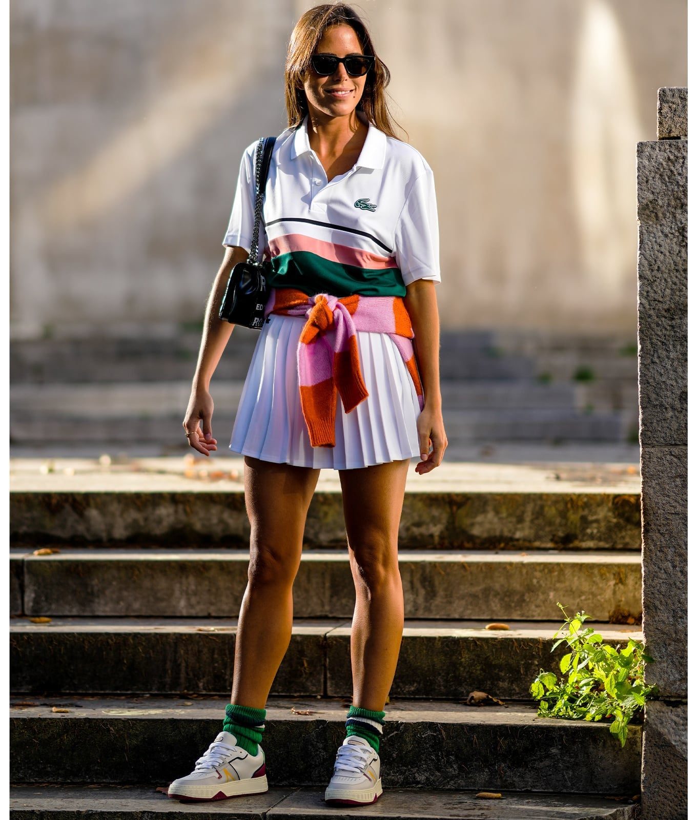 White Polo Shirt, Pleated Skirt, and Sweater at Waist — Trendy Tennis Outfits