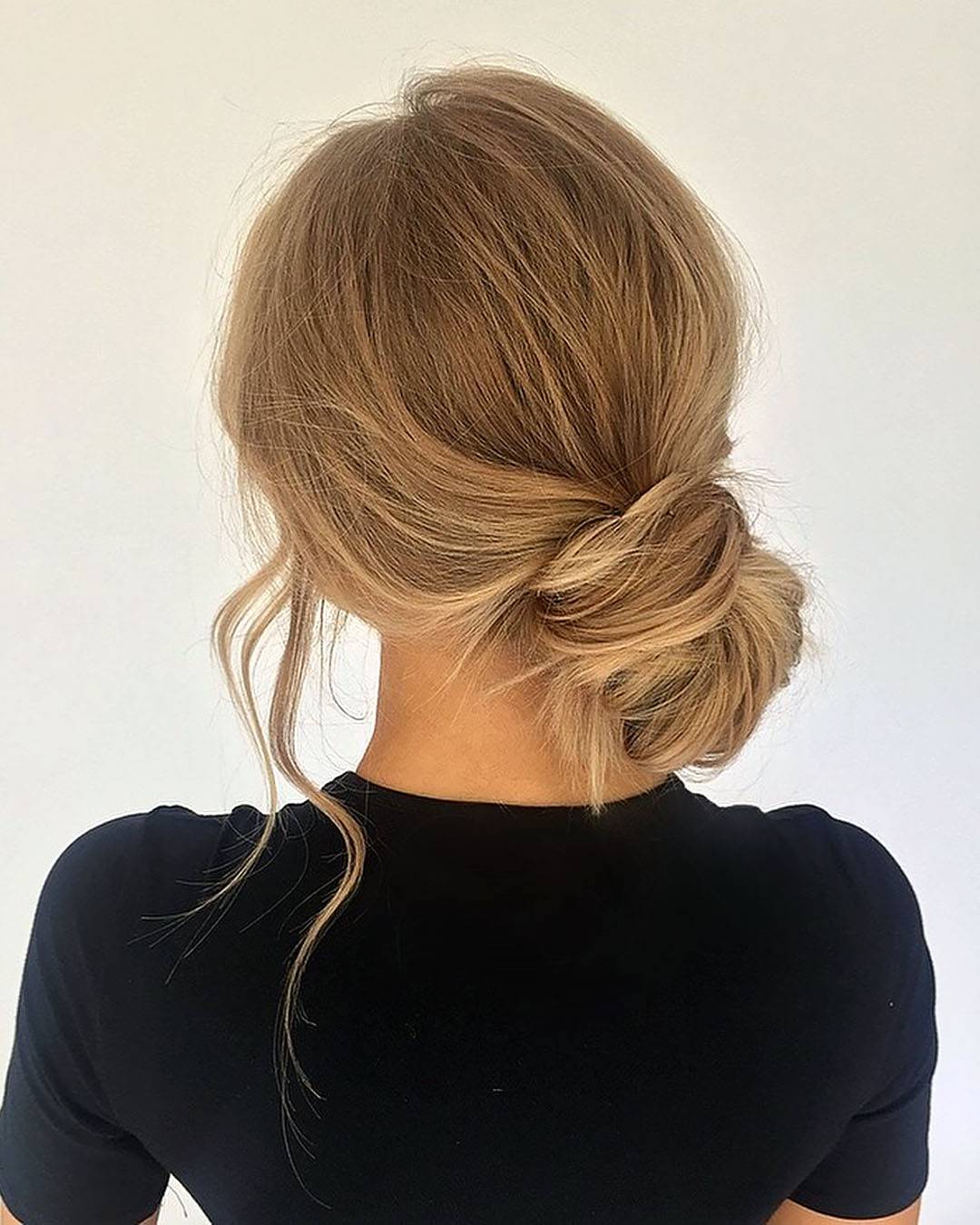 Low Messy Bun With Soft Waves Low Messy Bun With Soft Waves — Trendy Wedding Guest Updos