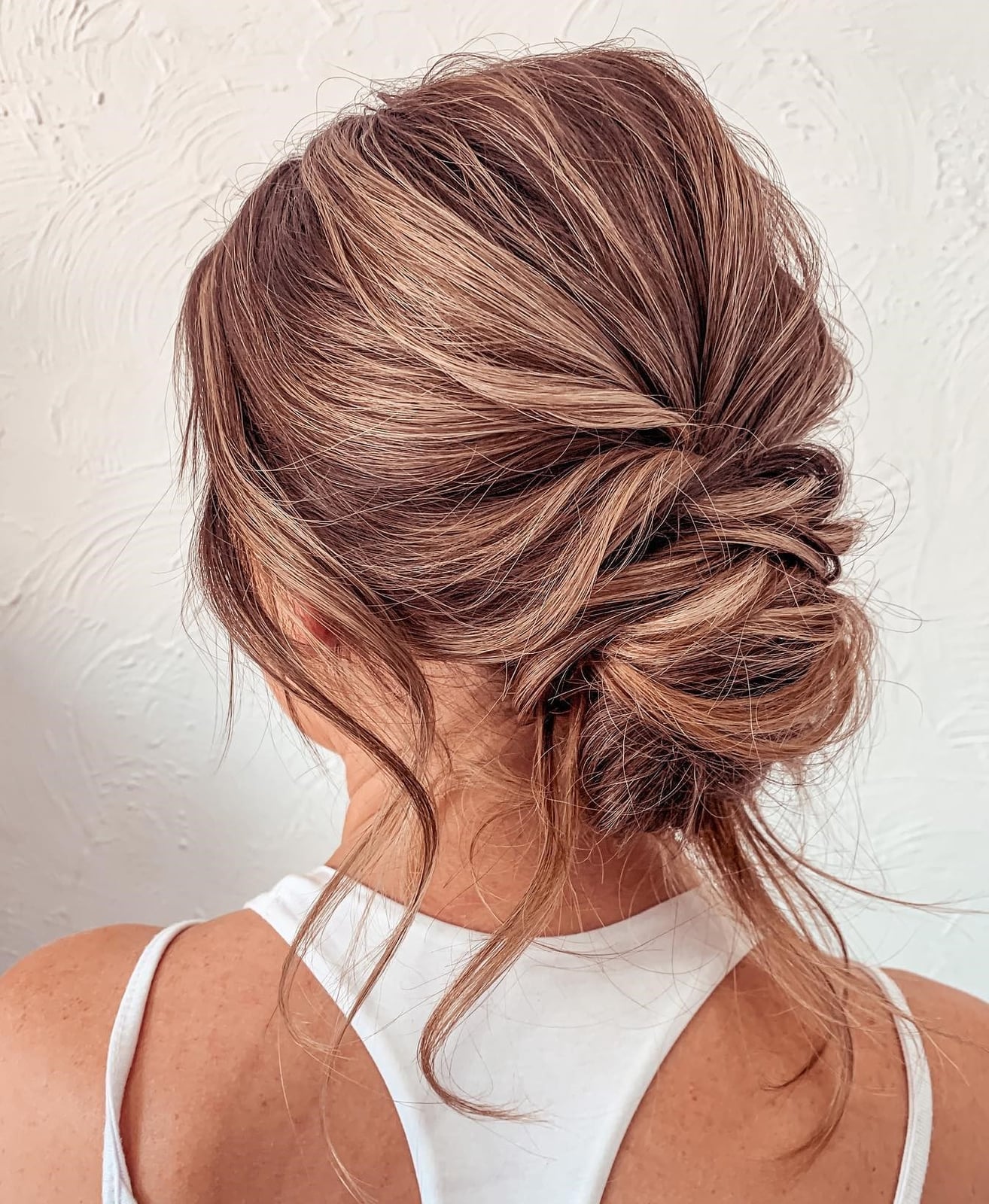 Messy Low Bun With Textured Finish Messy Low Bun With Textured Finish — Trendy Wedding Guest Updos
