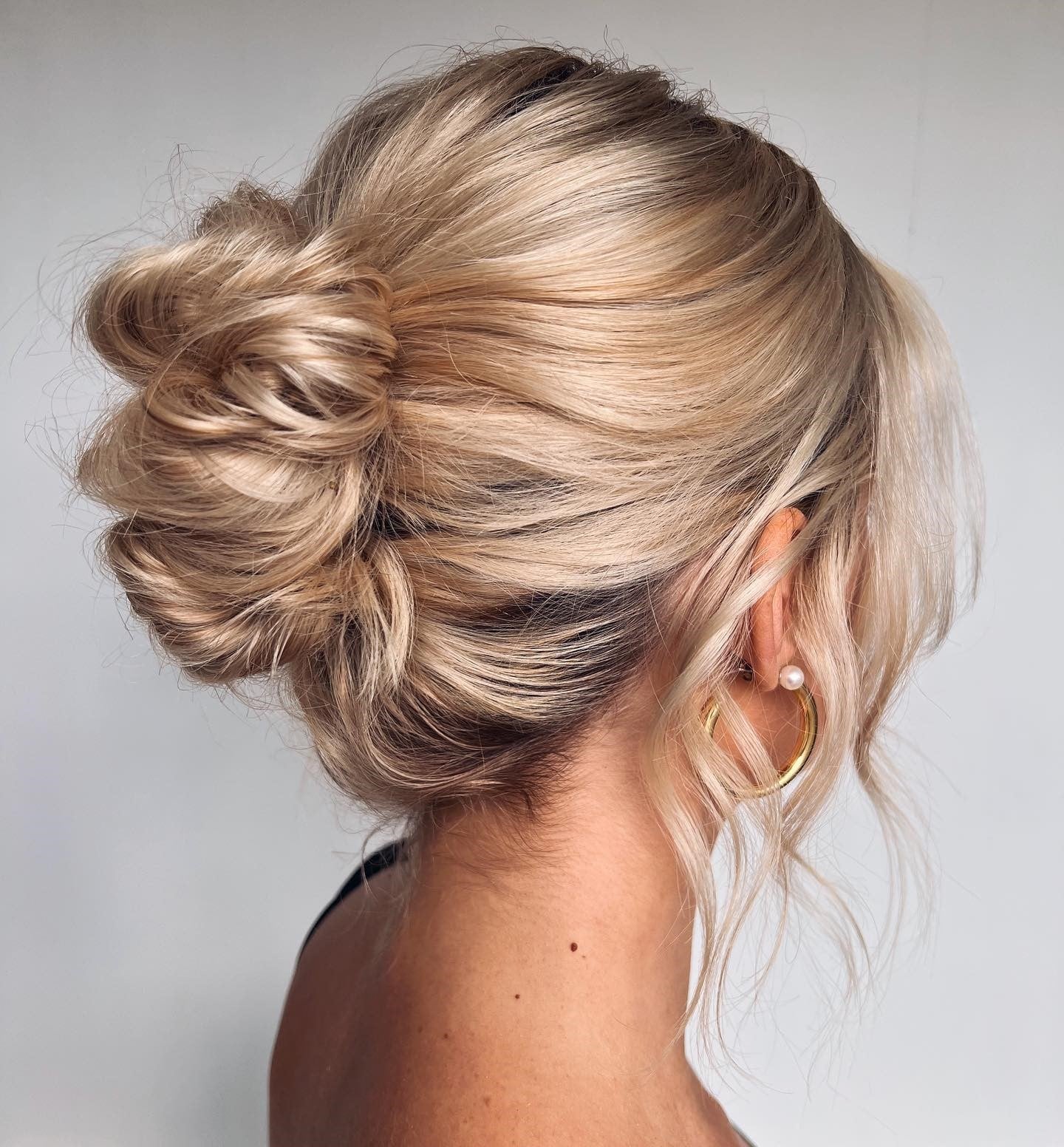 Soft Loose Bun With Face-Framing Tendrils, Close-Up Take Soft Loose Bun With Face-Framing Tendrils, Close-Up Take — Trendy Wedding Guest Updos