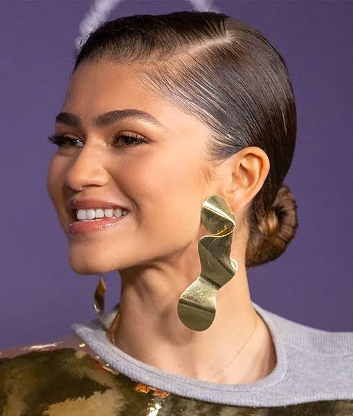 Sleek Low Bun With Wet Look Finish Sleek Low Bun With Wet Look Finish — Trendy Wedding Guest Updos