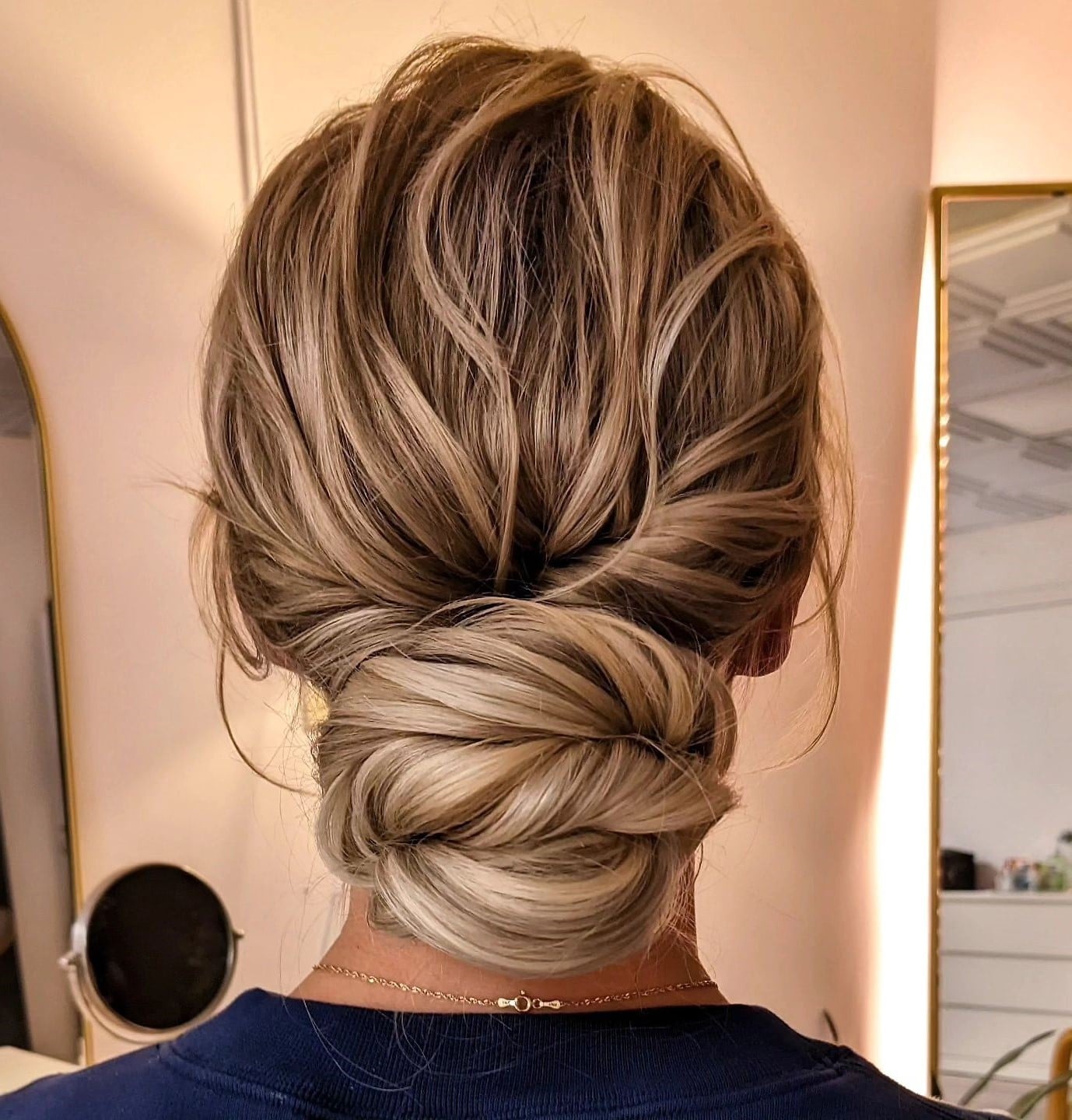 Intricate Twisted Low Bun With Balayage Intricate Twisted Low Bun With Balayage — Trendy Wedding Guest Updos
