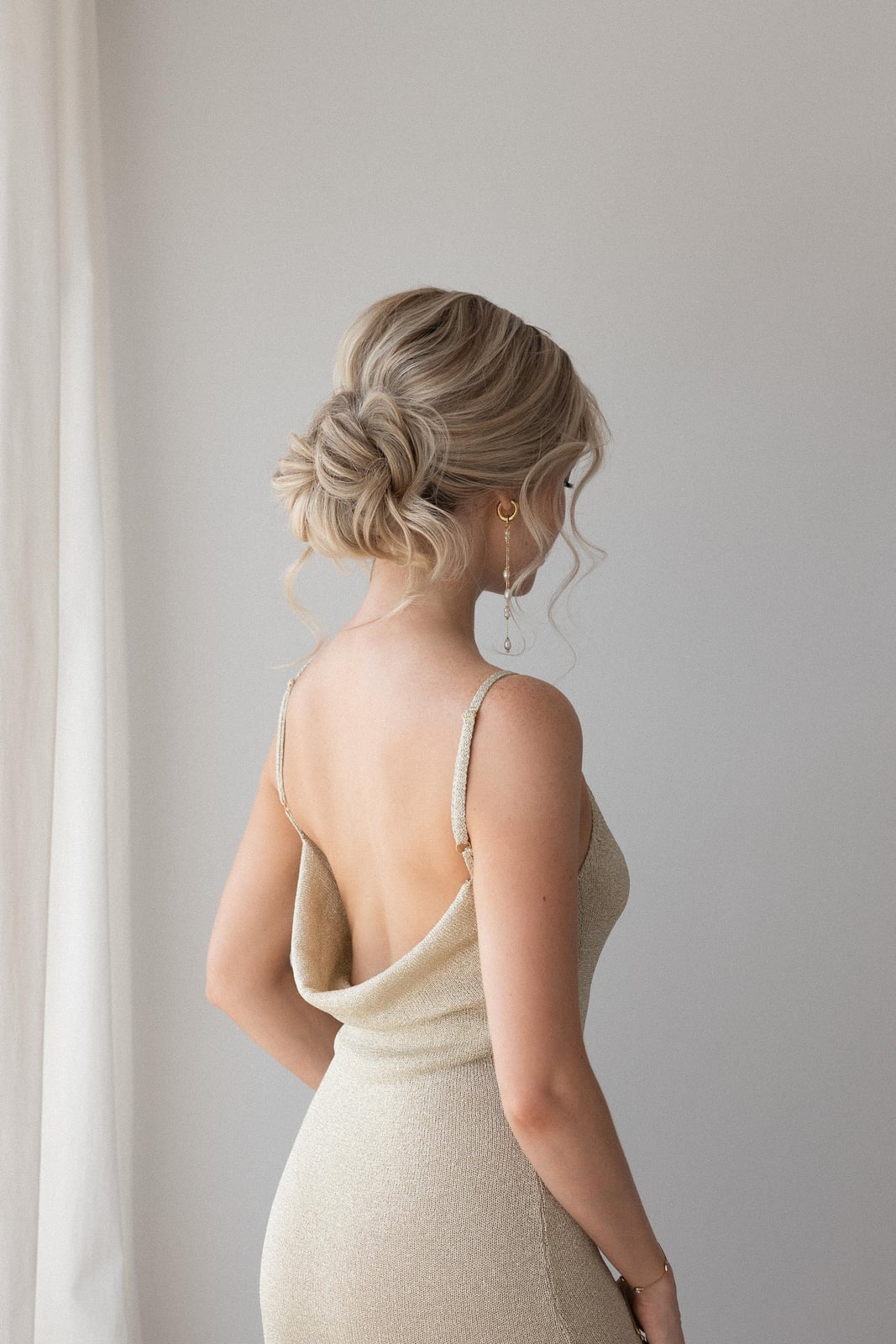 Twisted Low Bun With Loose Tendrils Twisted Low Bun With Loose Tendrils — Trendy Wedding Guest Updos