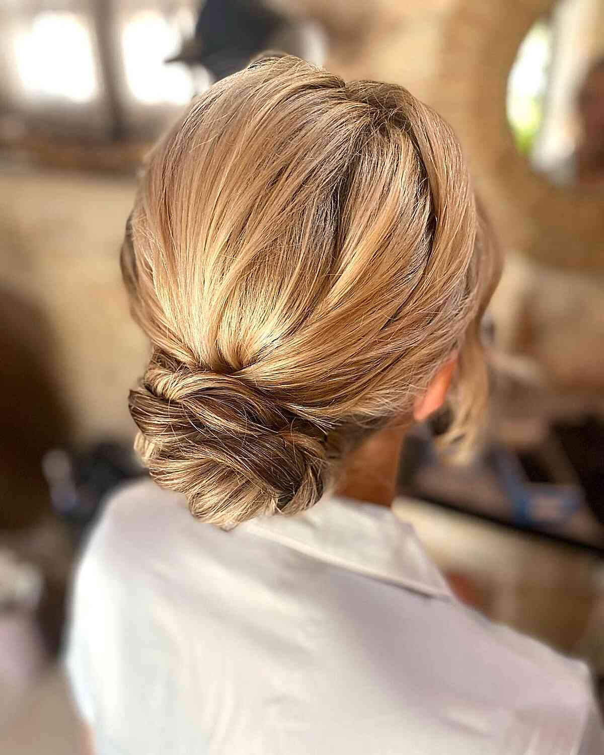 Low Twisted Updo With Subtle Highlights Low Twisted Updo With Subtle Highlights — Trendy Wedding Guest Updos