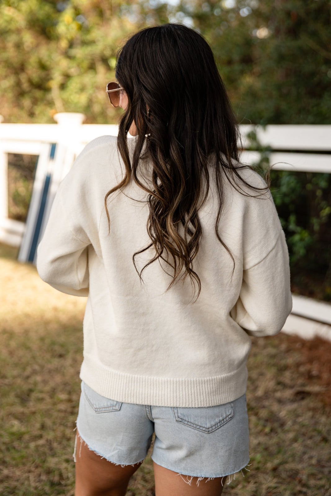Oversized Cream White Sweater with Red Script Detail — Trendy White Sweater Outfit