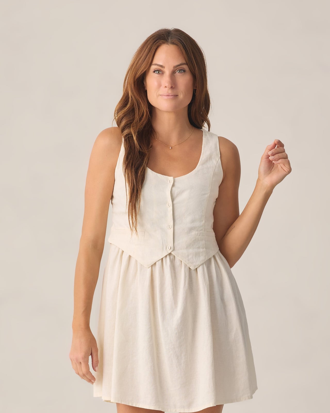 Cream Buttoned Vest Over a White Sleeveless Dress Cream Buttoned Vest Over a White Sleeveless Dress — Trendy White Vest Outfit