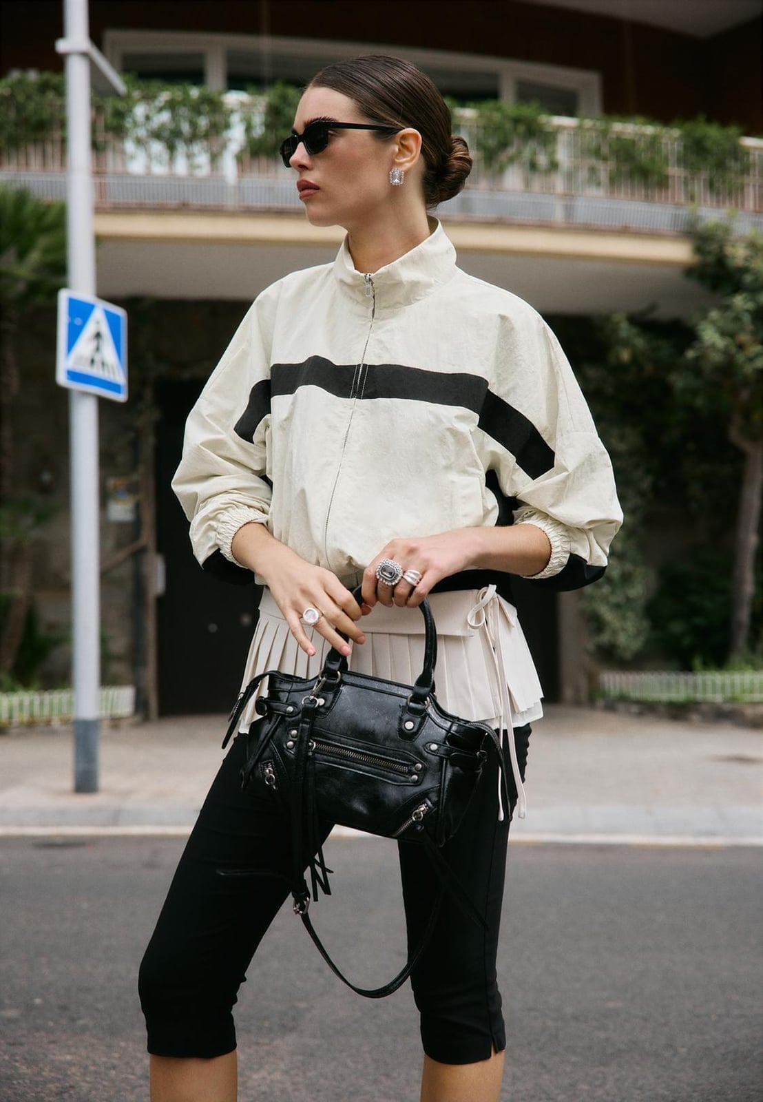 Striped Windbreaker With Pleated Underskirt and Black Leggings Striped Windbreaker With Pleated Underskirt and Black Leggings — Trendy Windbreaker Outfits