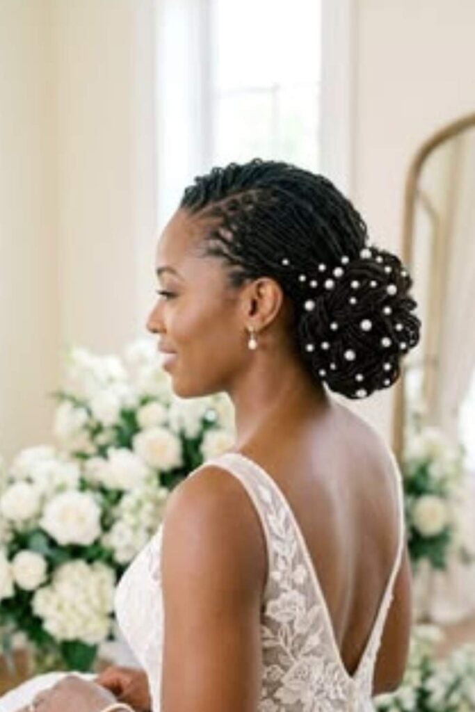 Black Coily Updo With Pearl Embellishments Black Coily Updo With Pearl Embellishments — Wedding Bun Ideas