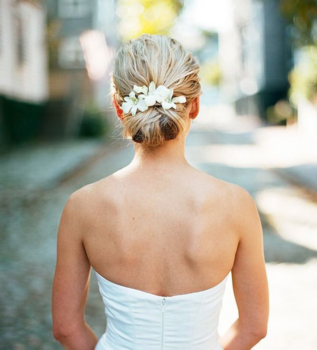 Blonde Textured Low Bun With Floral Adornments Blonde Textured Low Bun With Floral Adornments — Wedding Bun Ideas