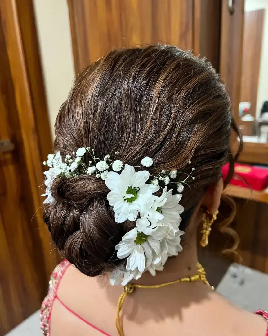 Dark Brown Sleek Braided Bun With Floral Accents Dark Brown Sleek Braided Bun With Floral Accents — Wedding Bun Ideas