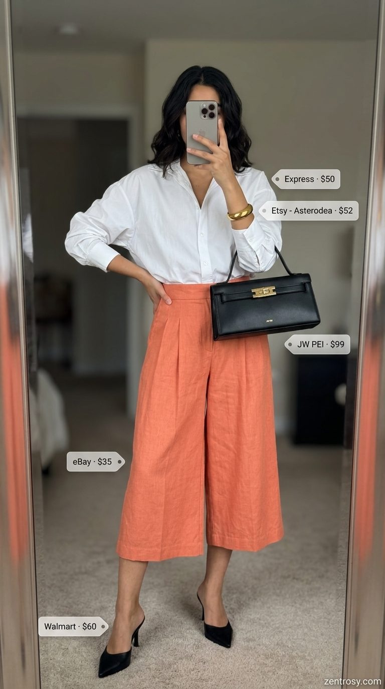 Sunset City Chic Culottes 2026 Coral tailored culottes for women 2026, styled with an oversized white shirt and mules for a sophisticated city look.